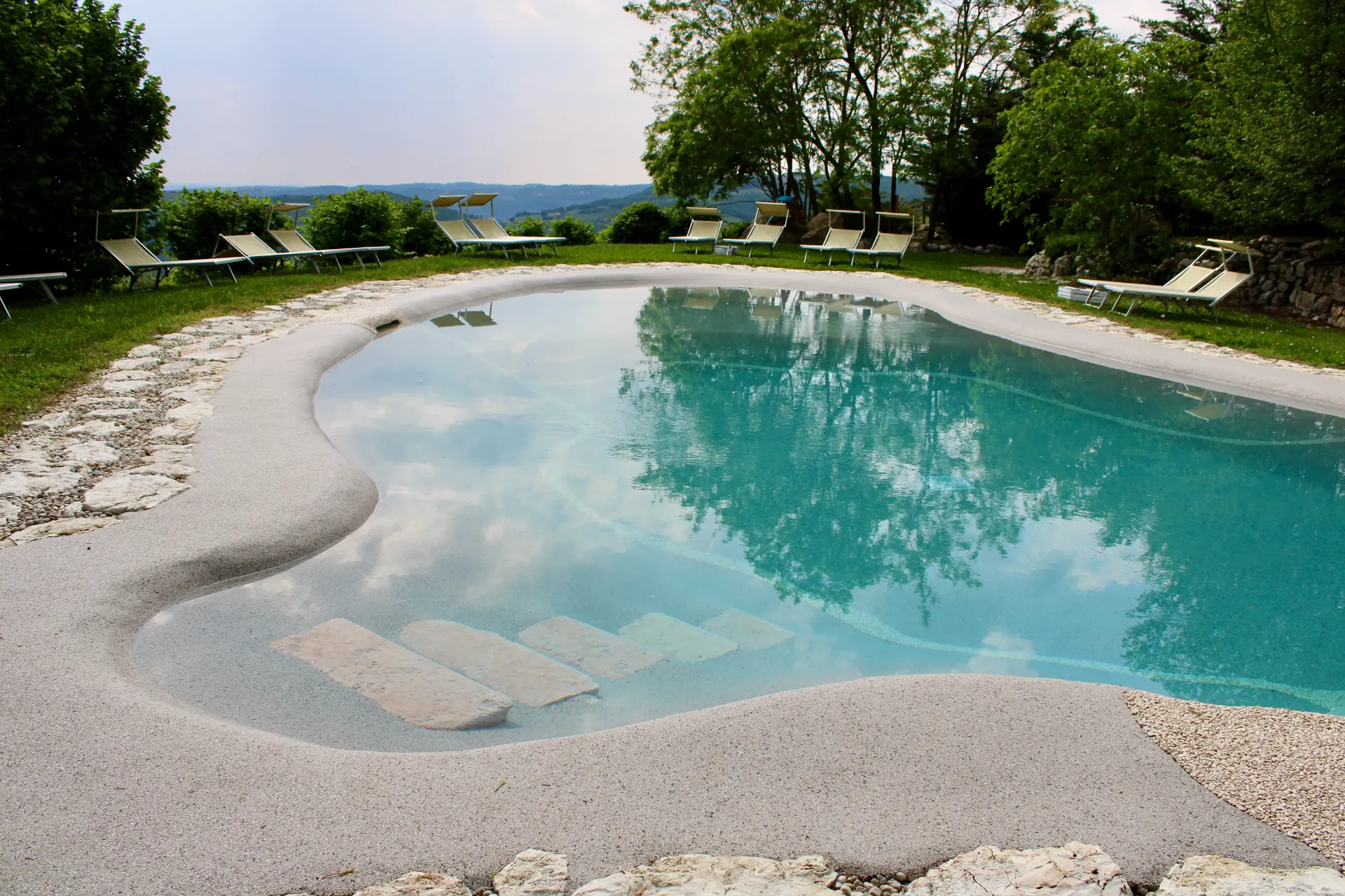 Naturi beach entry sand pool with hillside views