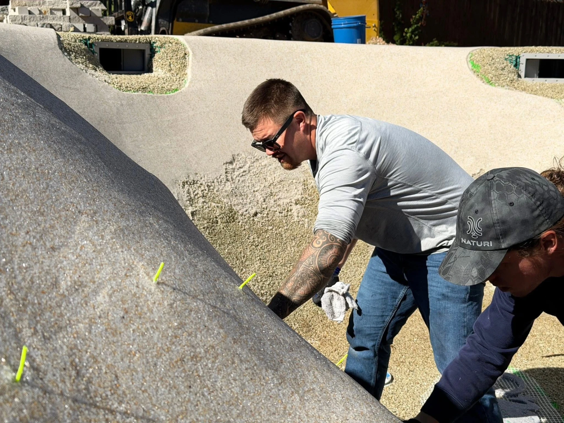 Naturi team building a sand pool alongside a certified installer
