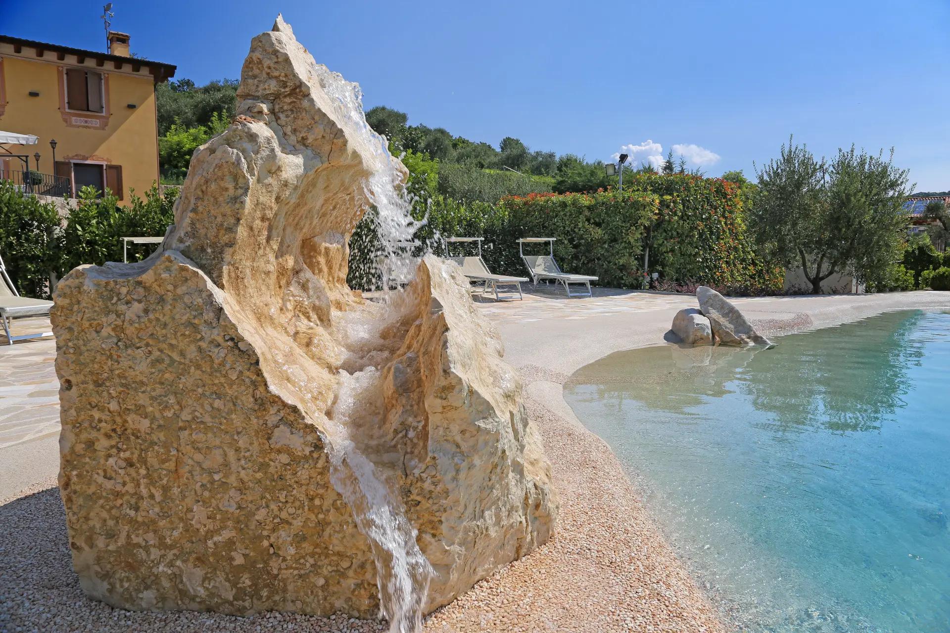 Builder crew hand-troweling a Naturi sand pool
