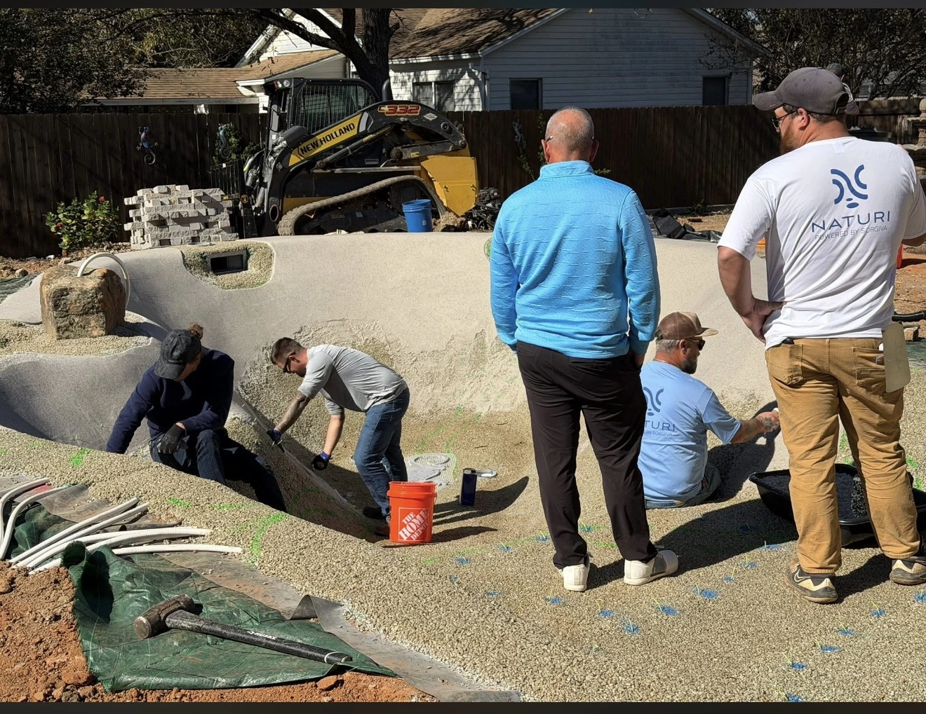 Naturi team building a sand pool alongside a certified installer