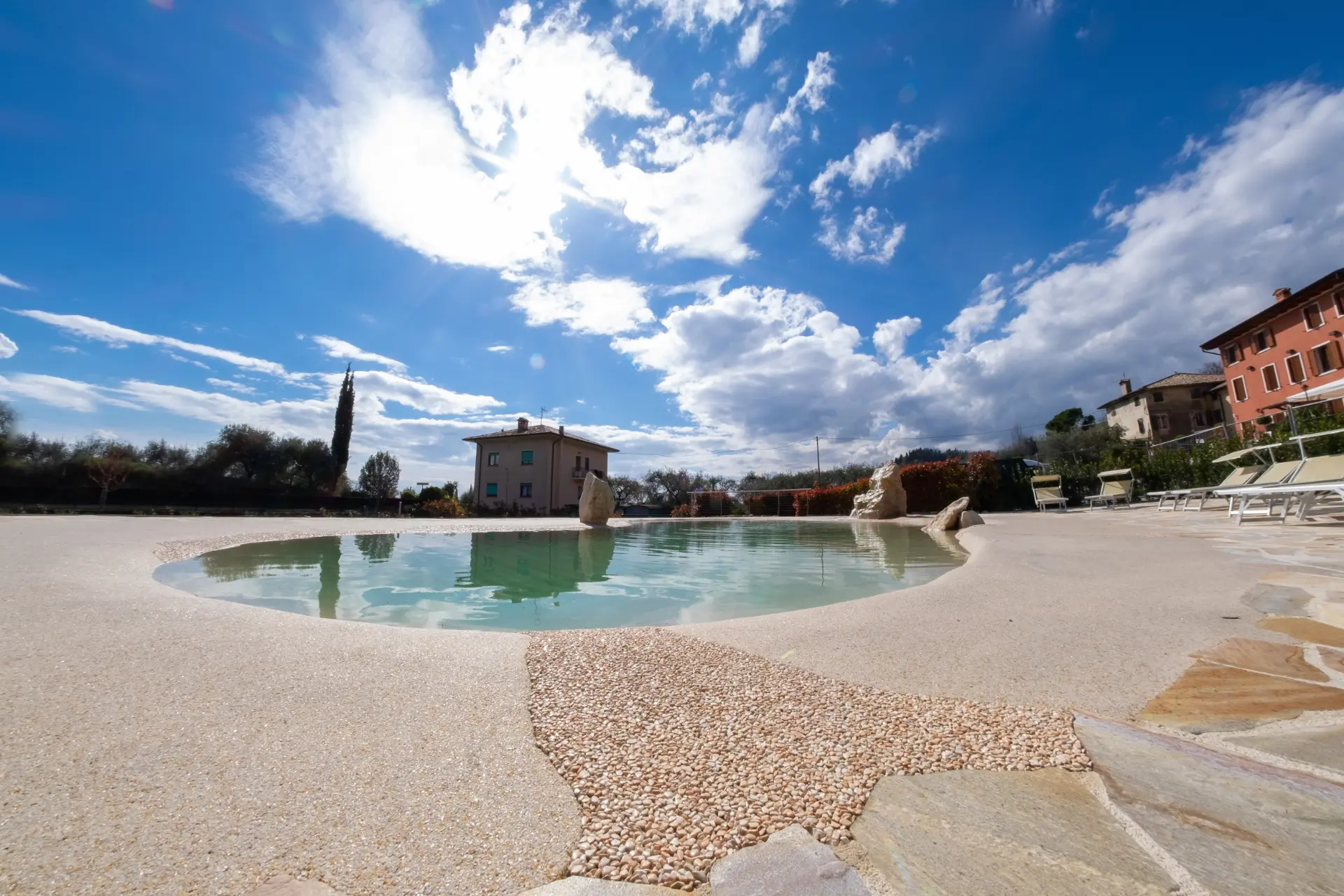 Builder crew hand-troweling a Naturi sand pool